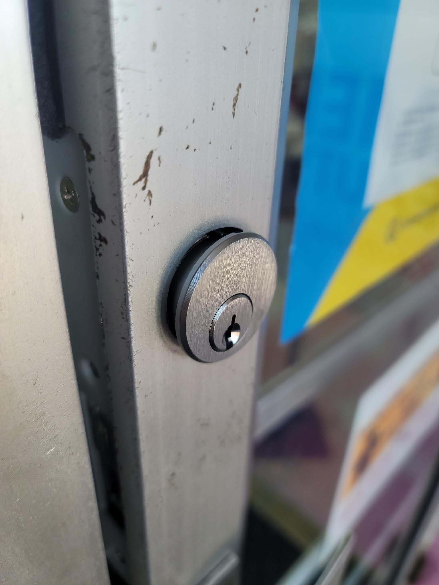 Brushed steel lock cylinder set into a door
