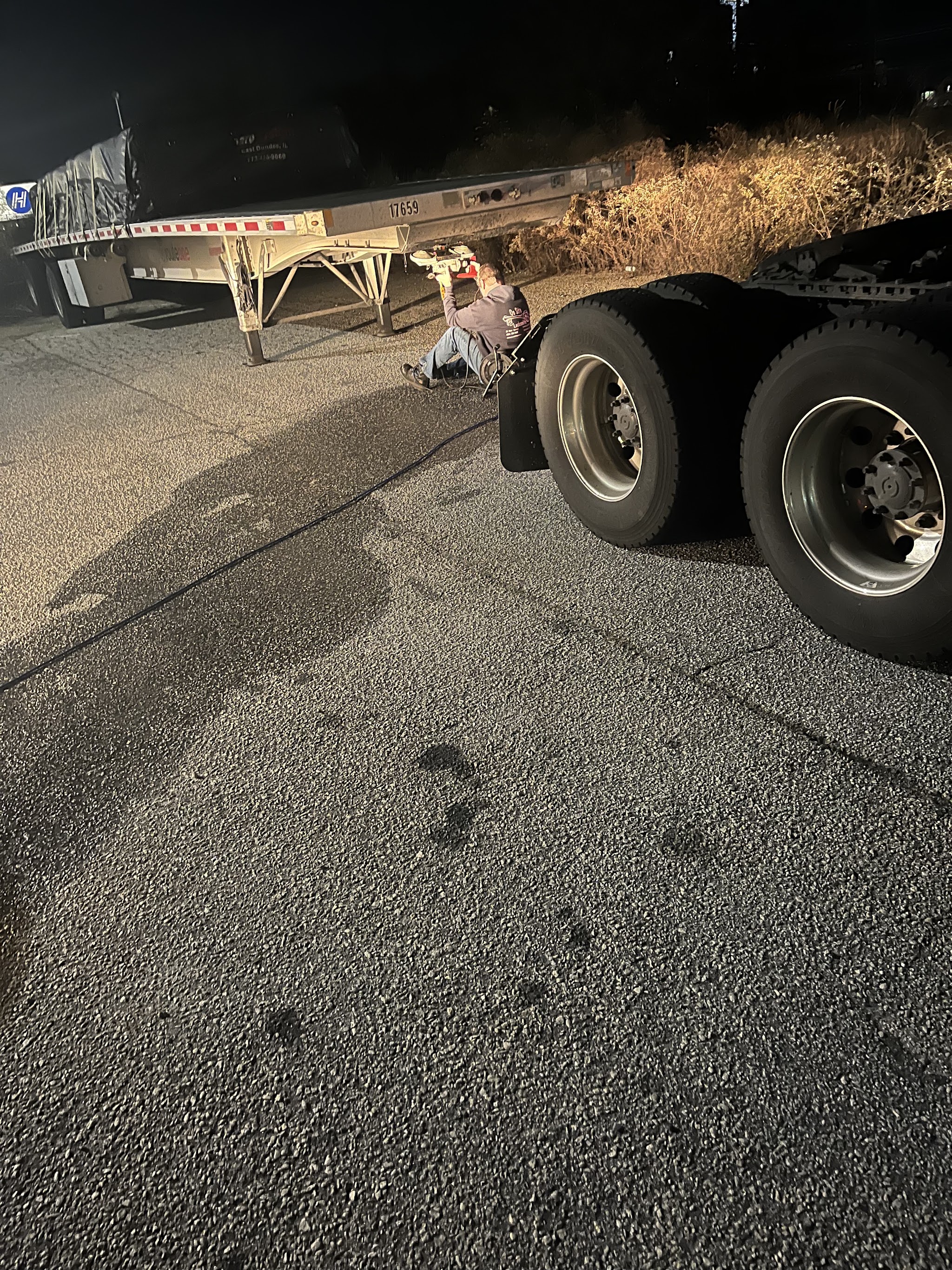 Working under a trailer at night under floodlight