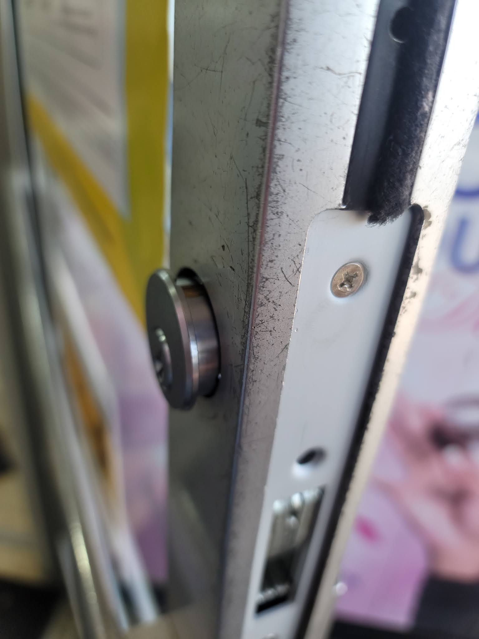 Lock cylinder and strike plate on a metal door